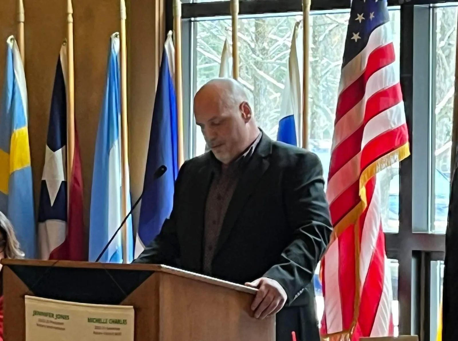 Aaron speaks at a podium during one of his two 6-hour addiction counseling workshops.